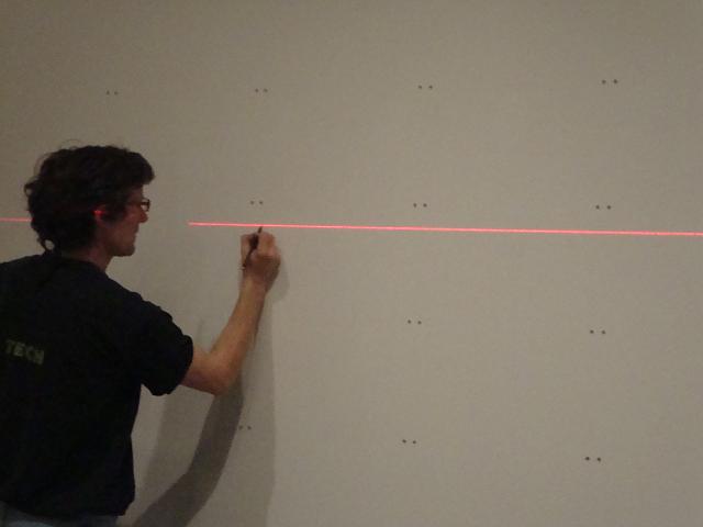 install - untitled (3).JPG - the laser level sure helped.   small rare-earth magnets are used to hold the paper onto the wall (screwhead)